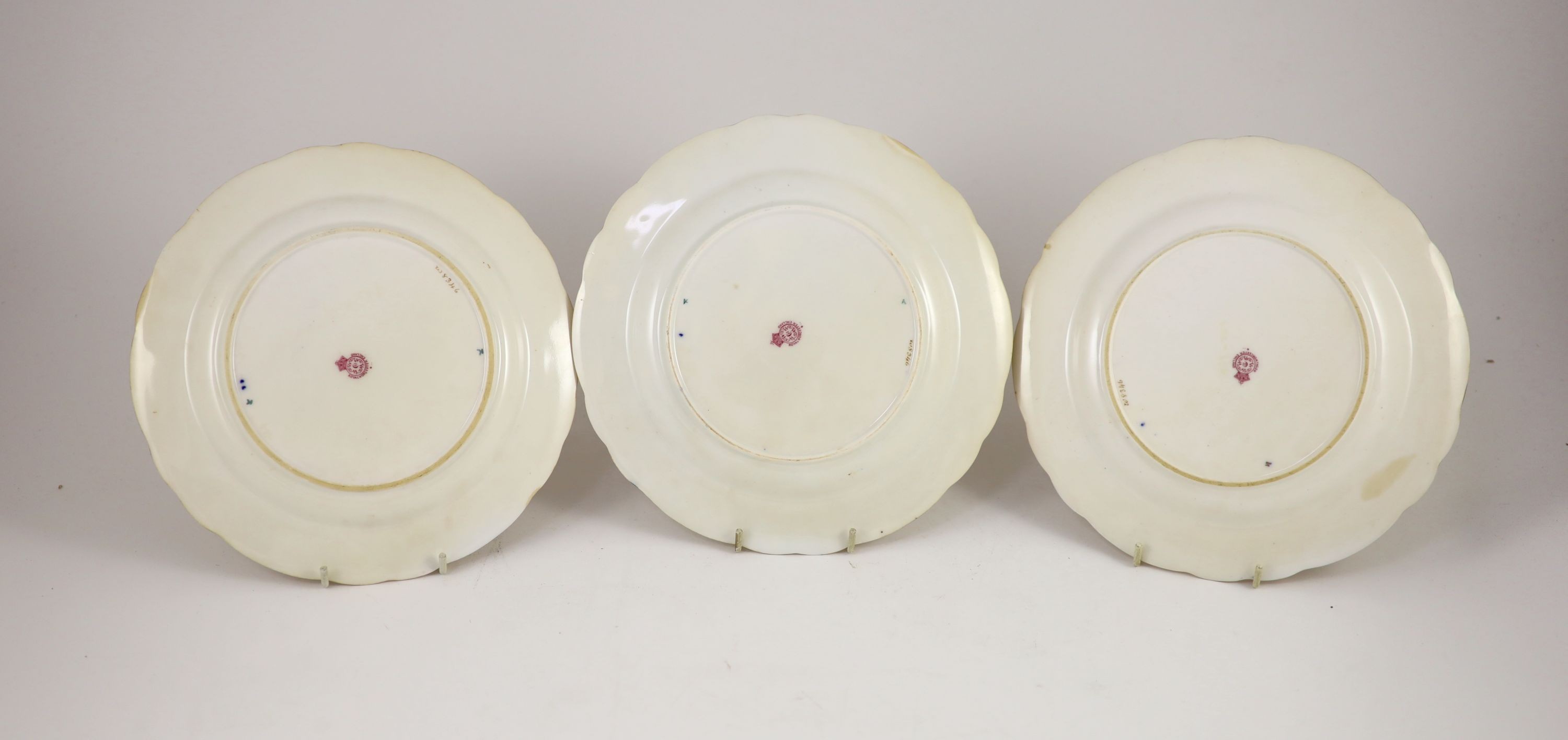 Three Royal Worcester fruit painted dessert plates, signed A. Shuck and E. Phillips, c.1918, 22.5cm diameter, two with ground off rim chip, one with tiny splinter chip